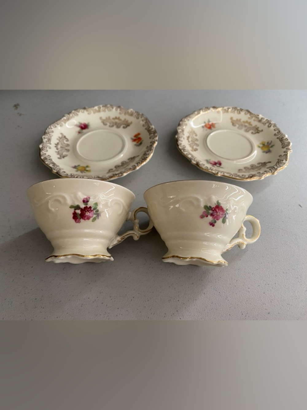 Schumann Bavaria Porcelain Floral Cream and Gold Tea Cup and Saucer Sets.